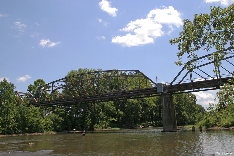 On a hot summer’s day, folks were swimming and fishing in the waters beneath the bridge